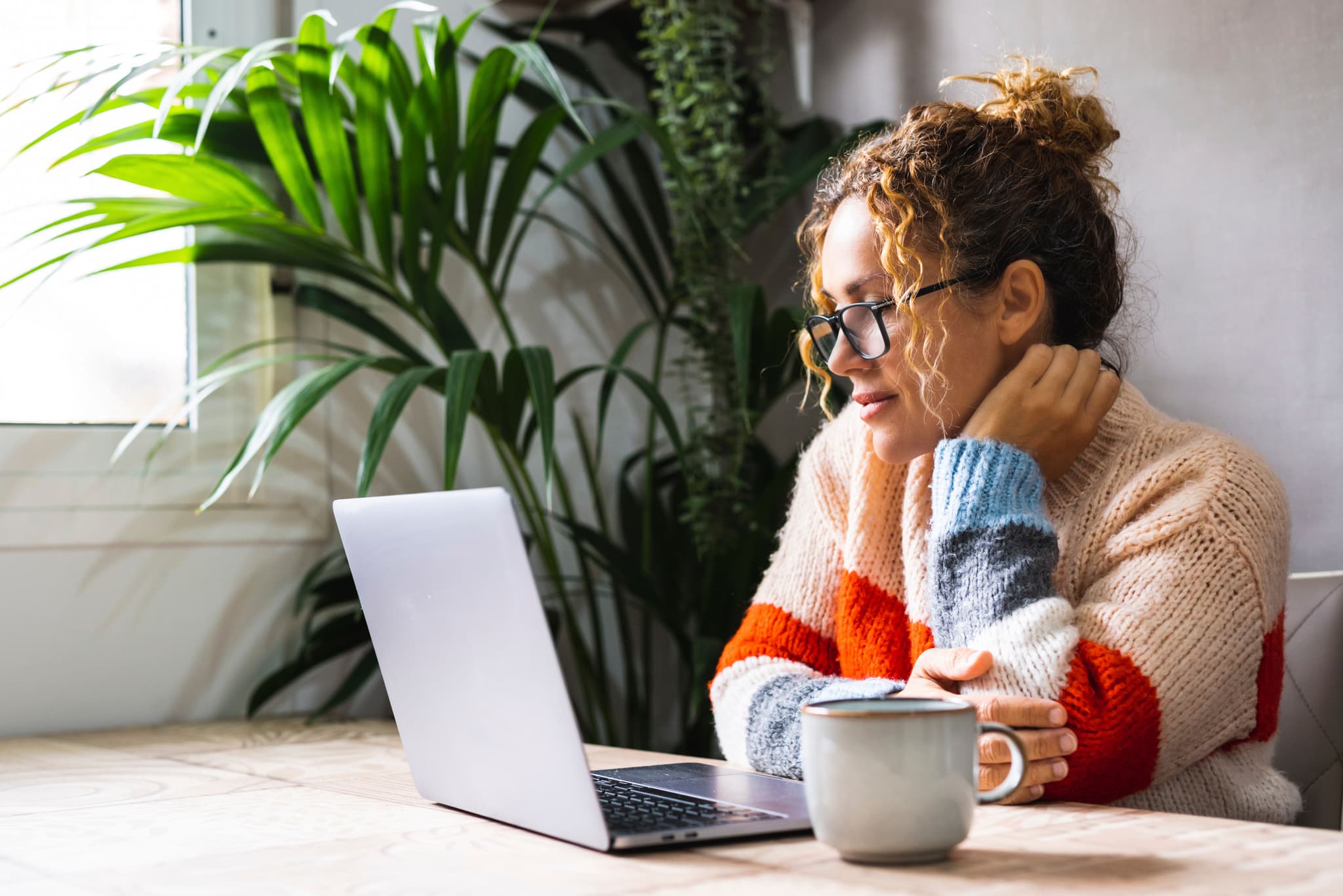 Woman looking at laptop.