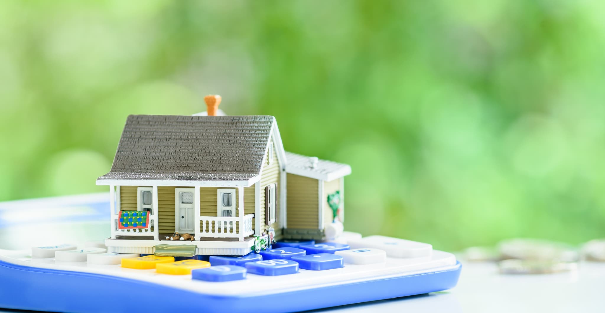 Image of model home on top of calculator