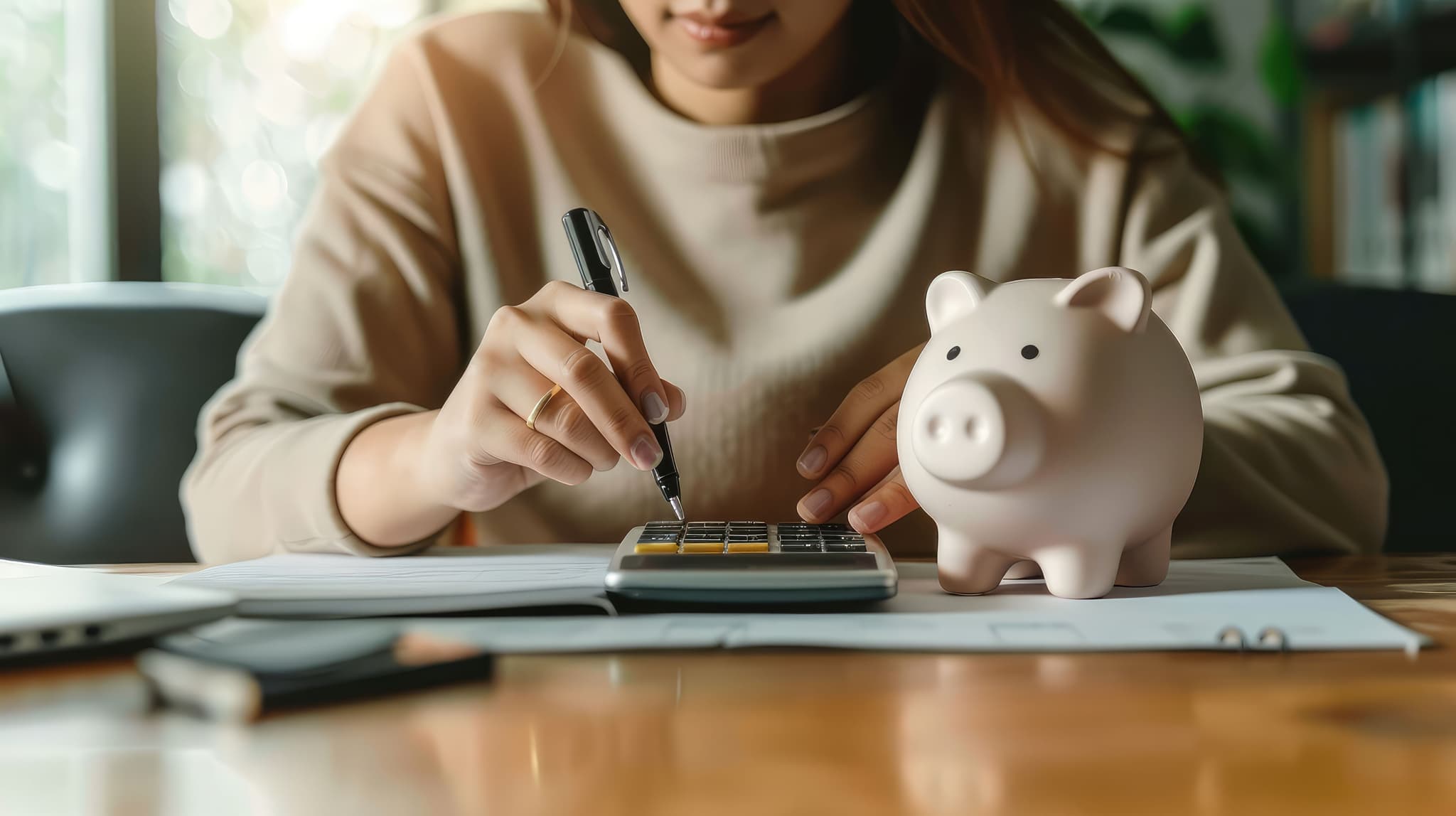 Woman with calculator and piggy bank